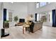 Bright living room with high ceilings, large windows, modern furniture, and hardwood floors at 22472 E Narrowleaf Cir, Aurora, CO 80016