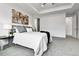 Relaxing main bedroom showcasing neutral tones, a large bed, stylish decor, and access to the bathroom at 22472 E Narrowleaf Cir, Aurora, CO 80016