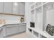 Clean mud room features plenty of shelves, hooks, and built in storage for a more organized space at 22472 E Narrowleaf Cir, Aurora, CO 80016