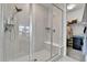 Clean, modern shower boasts sleek glass doors, convenient built in seating and a view into the walk-in closet at 22472 E Narrowleaf Cir, Aurora, CO 80016