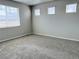 This bedroom features neutral walls, new carpet, and natural light from three windows with white blinds at 17170 E 90Th Pl, Commerce City, CO 80022