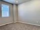 This bedroom features neutral walls, new carpet, and natural light from a window with white blinds at 17170 E 90Th Pl, Commerce City, CO 80022