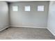 This bedroom features neutral walls, new carpet, and natural light from three windows with white blinds at 17170 E 90Th Pl, Commerce City, CO 80022
