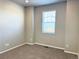 This bedroom features neutral walls, new carpet, and natural light from a window with white blinds at 17170 E 90Th Pl, Commerce City, CO 80022