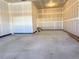 A clean, unfinished two car garage with sealed concrete floors and room for storage at 17170 E 90Th Pl, Commerce City, CO 80022