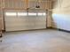Spacious two-car garage featuring ample lighting, drywall and a modern insulated garage door at 17170 E 90Th Pl, Commerce City, CO 80022