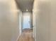 Inviting hallway featuring wood-like floors and white doors at 17170 E 90Th Pl, Commerce City, CO 80022
