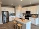 Bright kitchen with stainless steel appliances, a center island, and barstool seating at 17170 E 90Th Pl, Commerce City, CO 80022