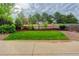 This backyard features a lush lawn, beautiful trees, a stained wood fence, and a concrete patio at 15828 Greenstone Ln, Parker, CO 80134