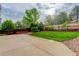 The backyard features a manicured lawn, concrete patio, rock features, and a wooden privacy fence at 15828 Greenstone Ln, Parker, CO 80134