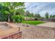 Backyard features a small grassy area, rock garden, privacy fence and a concrete patio space at 15828 Greenstone Ln, Parker, CO 80134