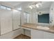 Well-lit bathroom featuring a vanity, sink, and sliding glass door shower at 15828 Greenstone Ln, Parker, CO 80134