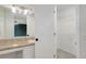 Bathroom featuring a vanity, sink, and an open door to a walk-in closet at 15828 Greenstone Ln, Parker, CO 80134