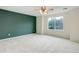 Large bedroom features a ceiling fan, carpet flooring, and a big window at 15828 Greenstone Ln, Parker, CO 80134