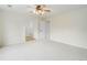 Bright bedroom featuring a ceiling fan, white carpet and doors leading to additional rooms at 15828 Greenstone Ln, Parker, CO 80134