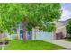 Two-story home with blue siding, brick details, a well-kept lawn, and mature shade trees at 15828 Greenstone Ln, Parker, CO 80134