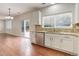 Bright kitchen boasts stainless steel dishwasher, stylish countertops, and access to the outdoor area at 15828 Greenstone Ln, Parker, CO 80134