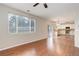 Bright living room featuring attractive floors, large windows, and a view into the updated kitchen at 15828 Greenstone Ln, Parker, CO 80134