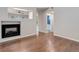 Open-concept living room with a fireplace, neutral paint, attractive flooring, and an open doorway at 15828 Greenstone Ln, Parker, CO 80134