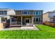 Exterior showcasing a well-maintained lawn, a covered patio, and a home exterior with complementary architectural elements at 24326 E Ohio Dr, Aurora, CO 80018