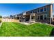 Spacious backyard featuring a well-maintained lawn and a charming covered porch, perfect for outdoor living at 24326 E Ohio Dr, Aurora, CO 80018