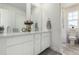 Bathroom featuring double sinks, a large mirror, granite counters, and a separate area with a shower and toilet, adding convenience at 24326 E Ohio Dr, Aurora, CO 80018