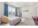 Bedroom with a large window, carpet, plush rug, a desk and chair, and an ensuite bathroom at 24326 E Ohio Dr, Aurora, CO 80018