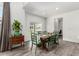 Bright dining room with wood floors, table with six green chairs, and slider access to backyard at 24326 E Ohio Dr, Aurora, CO 80018