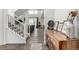 Welcoming entryway with stairs, wood floors, and decorative wooden cabinet at 24326 E Ohio Dr, Aurora, CO 80018