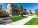 Attractive two-story home with a stone facade, covered porch, and a lush, green front lawn at 24326 E Ohio Dr, Aurora, CO 80018