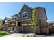 Beautiful two-story home featuring a stone facade, covered porch, and a well-manicured front yard at 24326 E Ohio Dr, Aurora, CO 80018