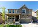 Charming two-story home with a stone-accented facade, covered porch, and well-maintained landscaping at 24326 E Ohio Dr, Aurora, CO 80018