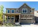 Charming two-story home with a stone-accented facade, covered porch, and well-maintained landscaping at 24326 E Ohio Dr, Aurora, CO 80018
