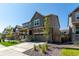 Beautiful two-story home featuring a stone facade, covered porch, and a well-manicured front yard at 24326 E Ohio Dr, Aurora, CO 80018