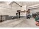 An unfinished two-car garage with access to power, shelving, and ample open floor space at 24326 E Ohio Dr, Aurora, CO 80018