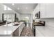 Bright, open kitchen with a large island, stainless steel appliances, and seamless flow to the dining area at 24326 E Ohio Dr, Aurora, CO 80018