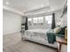 Bright main bedroom with a tray ceiling, three windows and a decorative bed frame at 24326 E Ohio Dr, Aurora, CO 80018