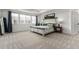 Spacious main bedroom with a large bed, carpet, three windows, and elegant decor at 24326 E Ohio Dr, Aurora, CO 80018