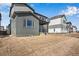 Exterior view of a backyard featuring gray siding and unfinished landscaping at 9982 Wheeling St, Commerce City, CO 80022