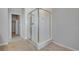 This bathroom features an enclosed glass shower with tiled walls and floors at 9982 Wheeling St, Commerce City, CO 80022