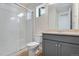 Bathroom featuring walk-in shower, vanity with quartz countertop, and gray cabinets at 9982 Wheeling St, Commerce City, CO 80022