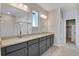 Bathroom with double vanity, quartz countertop and modern lighting at 9982 Wheeling St, Commerce City, CO 80022
