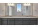 Bathroom with double vanity, grey cabinetry, quartz countertop and modern lighting at 9982 Wheeling St, Commerce City, CO 80022