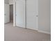 Bright bedroom featuring carpeted floors and closet with white sliding doors at 9982 Wheeling St, Commerce City, CO 80022