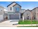 Two-story home featuring a two-car garage, gray siding and a well-maintained lawn at 9982 Wheeling St, Commerce City, CO 80022