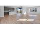 Open-concept living area with hardwood floors, recessed lighting, and a sliding door to an outdoor balcony at 9982 Wheeling St, Commerce City, CO 80022
