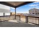 Covered patio with black railing, overlooking an undeveloped community at 9982 Wheeling St, Commerce City, CO 80022