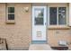 Back entrance of home showing brick and a white door, offering convenient access at 1549 S Evanston St, Aurora, CO 80012