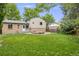 Expansive backyard featuring a well-maintained lawn and a circular wooden deck at 1549 S Evanston St, Aurora, CO 80012