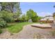 Lush backyard with a fire pit, patio, and surrounding trees, great for outdoor entertaining at 1549 S Evanston St, Aurora, CO 80012